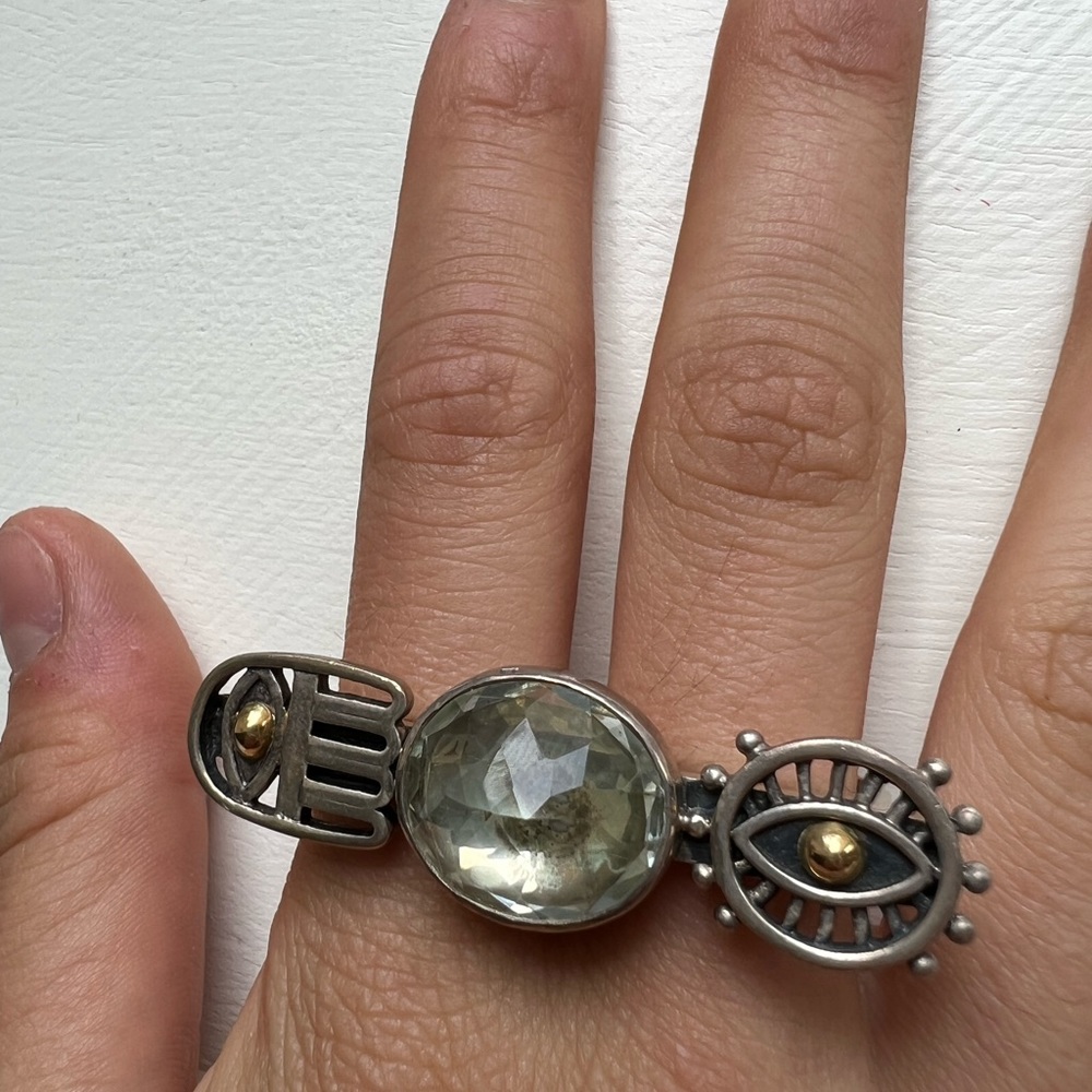 One-of-kind protective symbols double ring in silver and 18-k gold.